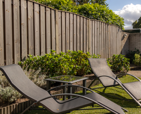 deck chairs by fence