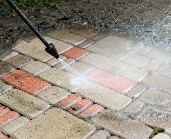 Jet washing a block paving driveway